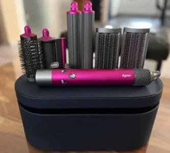 a group of hair dryers and hair rollers on a black box