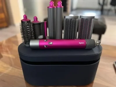 a group of hair dryers and hair rollers on a black box